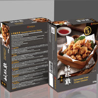 Two black-and-white packages of frozen Taiwan Crispy Chicken are shown. One package, facing forward, displays the name of the product and an image reminiscent of a Taiwanese night-market street snack, while the other package displays the ingredients and nutritional information.